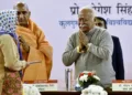 RSS Chief Mohan Bhagwat greets a woman during a book launch event, in New Delhi on Tuesday. (ANI Photo/Jitender Gupta)