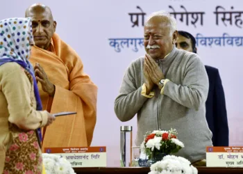 RSS Chief Mohan Bhagwat greets a woman during a book launch event, in New Delhi on Tuesday. (ANI Photo/Jitender Gupta)