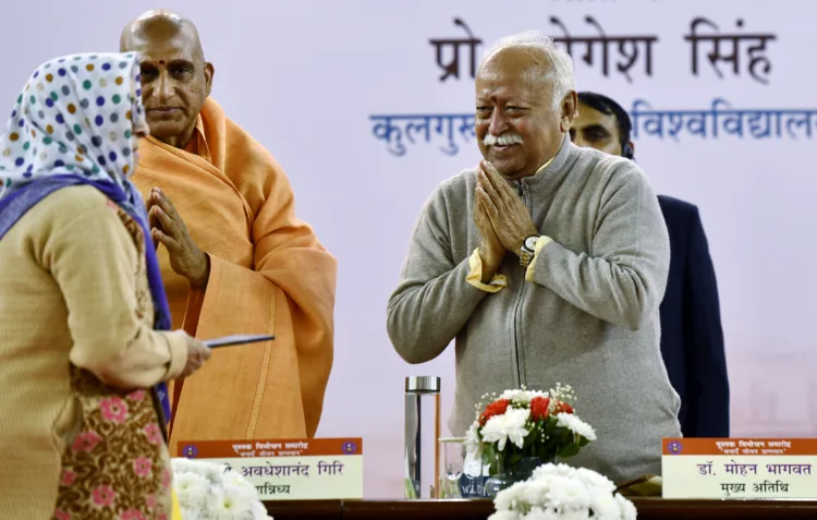 RSS Chief Mohan Bhagwat greets a woman during a book launch event, in New Delhi on Tuesday. (ANI Photo/Jitender Gupta)