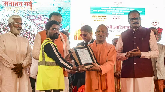 Prayagraj: UP CM Yogi Adityanath felicitates a municipal worker during the closing ceremony a day after the conclusion of Maha Kumbh 2025, in Prayagraj, Thursday, Feb. 27, 2025.